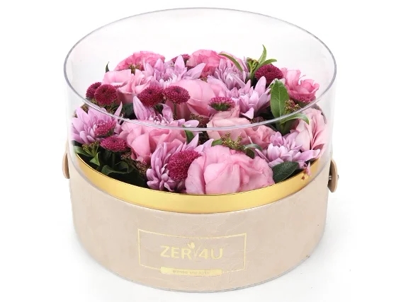 סידור פרחים בגווני ורוד בקופסא עגולה