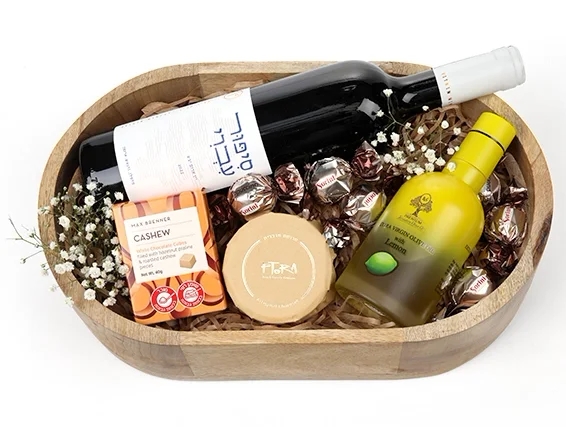 מארז שי לפסח המכיל בקבוק יין אדום, חרוסת, שוקולד ושמן זית